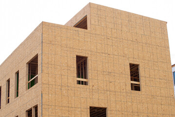 Construction of a new apartment building with the walls framed and covered with plywood modern