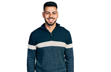 Young hispanic man with beard wearing casual winter sweater with a happy and cool smile on face. lucky person.