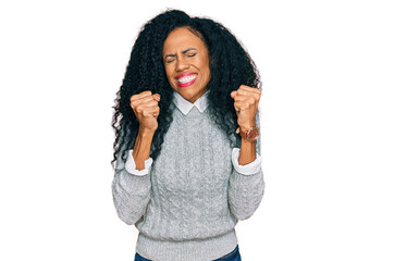 Middle age african american woman wearing casual clothes excited for success with arms raised and eyes closed celebrating victory smiling. winner concept.