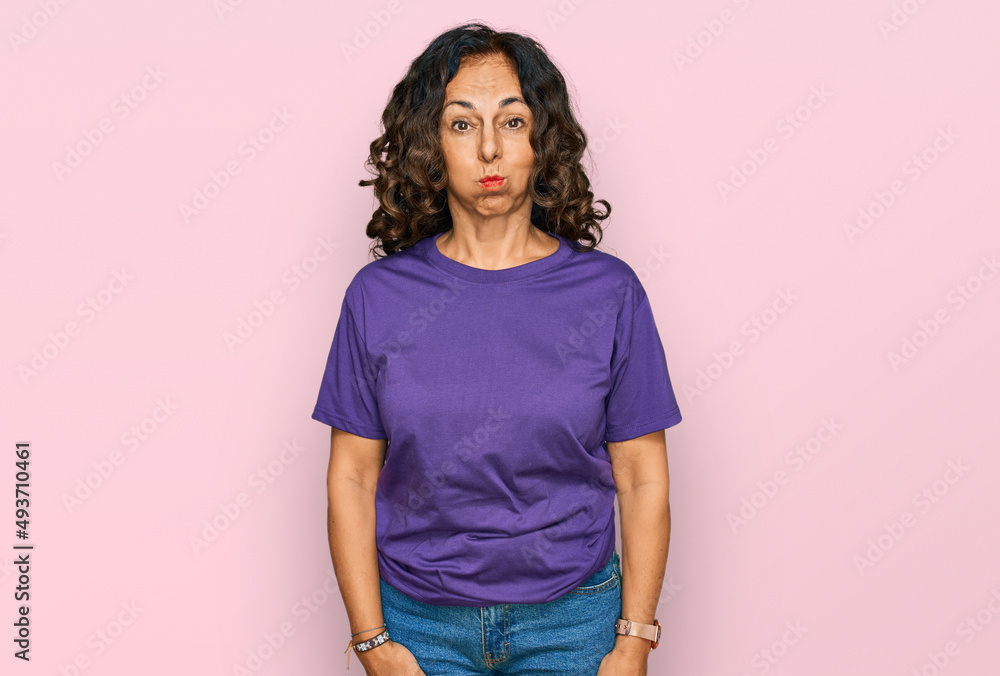 Canvas Prints Middle age hispanic woman wearing casual clothes puffing cheeks with funny face. mouth inflated with air, crazy expression.