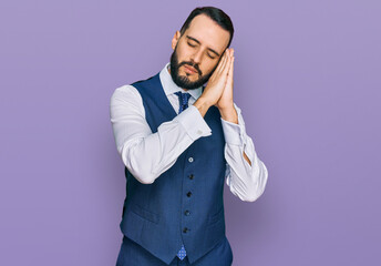 Young man with beard wearing business vest sleeping tired dreaming and posing with hands together...