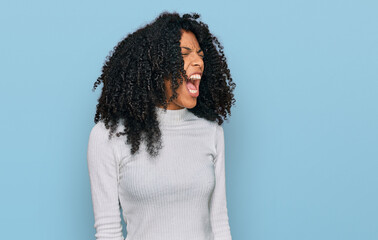 Young african american girl wearing casual clothes angry and mad screaming frustrated and furious,...