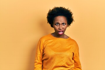 Fototapeta na wymiar Young african american woman wearing casual clothes in shock face, looking skeptical and sarcastic, surprised with open mouth