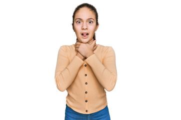 Fototapeta premium Beautiful brunette little girl wearing casual sweater shouting and suffocate because painful strangle. health problem. asphyxiate and suicide concept.