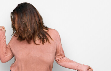 Young plus size woman wearing casual clothes and glasses dancing happy and cheerful, smiling moving casual and confident listening to music