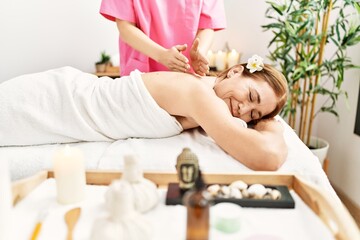 Obraz na płótnie Canvas Middle age caucasian woman having back massage at beauty center