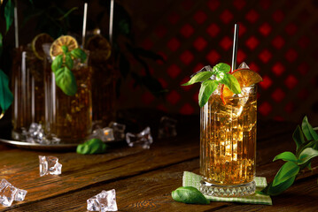Glass of long island ice tea cocktail decorated with mint. Cuba Libre drink with strong drinks low...