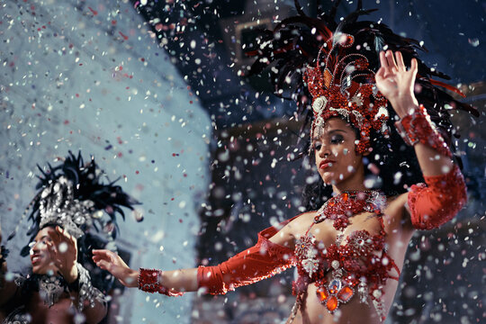 Fiery festival dancers. Shot of two beautiful samba dancers performing in a carnival.