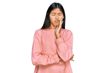 Beautiful young asian woman wearing casual winter sweater touching mouth with hand with painful expression because of toothache or dental illness on teeth. dentist