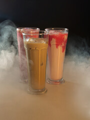 three milkshakes in glass with smoke effect