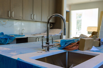 Close up of sinks in modern kitchen with marble granite island stone