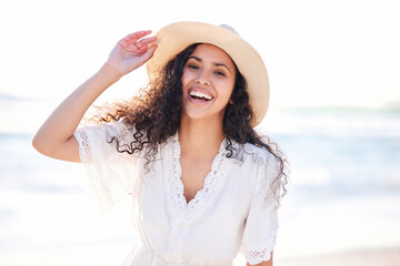 Beach days are happy days. Shot of a young woman enjoying a day at the beach.