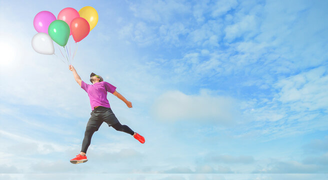 Colorful Balloons, Men Floating With Balloons. Sportman Holding On To Balloons Above A Sky Trying To Escape Hand Bursting His Balloon Concept For Challenge Or Bullying