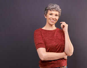 Smile, its worth it. Studio portrait of a confident elderly woman against a gray background.