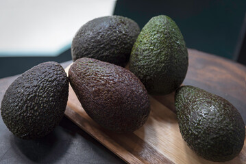 Avocado on wooden tray . Fruit healthy food concept.