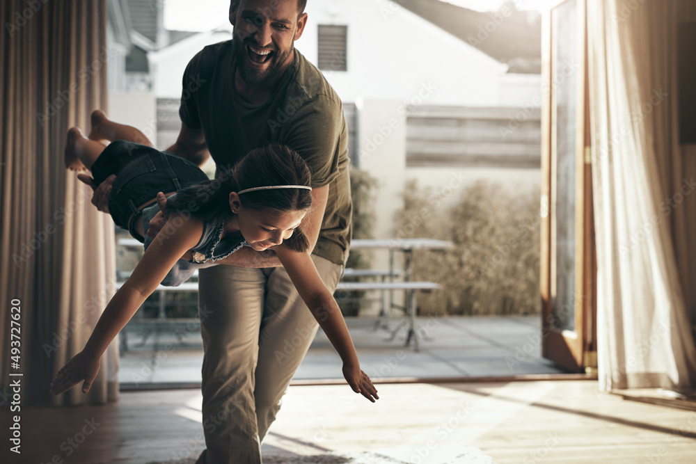 Aufkleber give them wings and teach them to fly. shot of a young man enjoying playtime with his daughter at ho