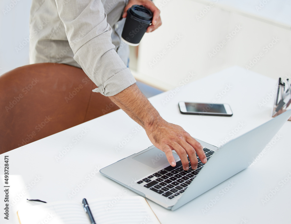 Poster First thing is to check the emails. Shot of a unreconizable man using his laptop at work in a modern office.