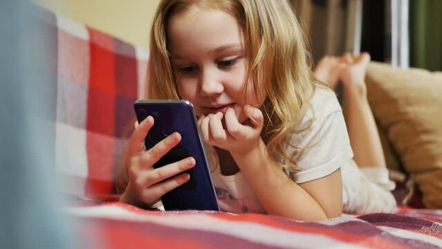a caucasoid teenage girl of six years old had a video call with friends on the couch and left. Slow motion.
