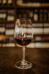 Glass of red wine on table.vintage tone.vertical image