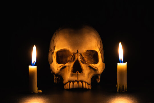 Skull on a black background with candles