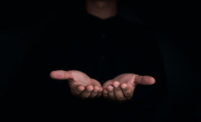 Give two hands with nothing on both on dark background with copy space. Close-up receiving gesture...
