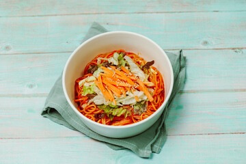 Jjolmyeon refers to thick flour noodles characterized by their chewiness. It is usually topped with cucumber, cabbage, and bean sprout and mixed with a gochujang (red chili paste) sauce at the table.