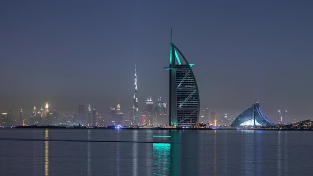 Skyline of Dubai by night with Burj Al Arab from the Palm Jumeirah timelapse.