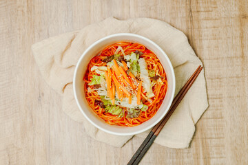 Jjolmyeon refers to thick flour noodles characterized by their chewiness. It is usually topped with cucumber, cabbage, and bean sprout and mixed with a gochujang (red chili paste) sauce at the table.