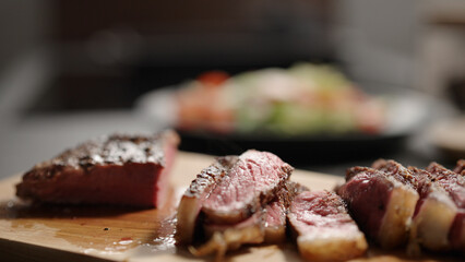sliced new york steak on olive wood board