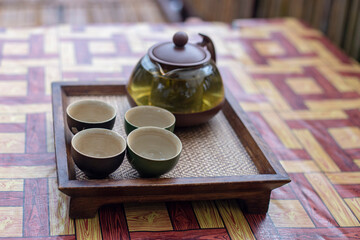 Set of tea cups on a wooden tray