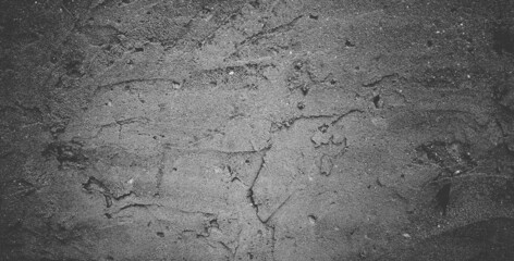 Black concrete wall or dark gray rough grainy stone texture background.