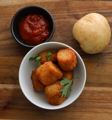 Various appetizers including potato tots, crumbed chicken nuggets and bitterballen. 