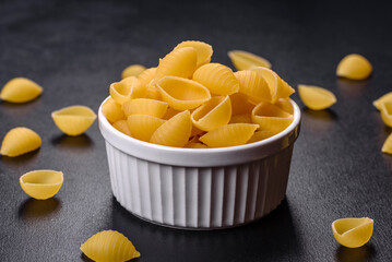 Detail of macaroni pasta useful as a background, texture. Dry pasta. Top view on black background