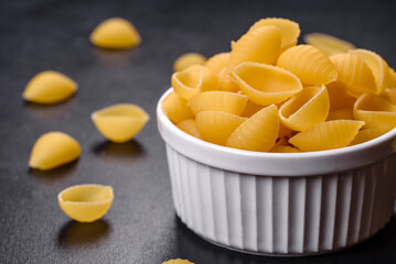 Detail of macaroni pasta useful as a background, texture. Dry pasta. Top view on black background
