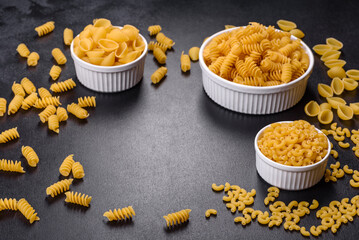 Detail of macaroni pasta useful as a background, texture. Dry pasta. Top view on black background