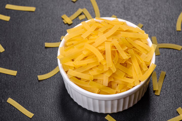 Detail of macaroni pasta useful as a background, texture. Dry pasta. Top view on black background