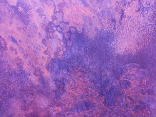 A rusty purple metal wall with spots and scuffs. Vintage background with texture. Rough surface.
