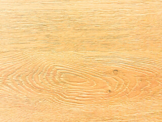 An old yellow wooden wall with annual tree rings. Vintage yellow background with wooden texture.