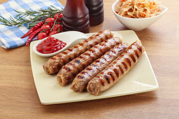 Grilled sausages with cabbage and sauce