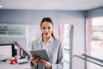 Portrait of a businesswoman using tablet at office for work.