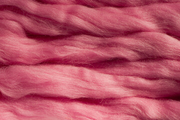Fototapeta na wymiar Pink wool for felting close-up