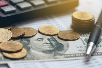  Inflation, tax, cash flow, and another financial concept.US dollar and coins, calculator, pen, on...