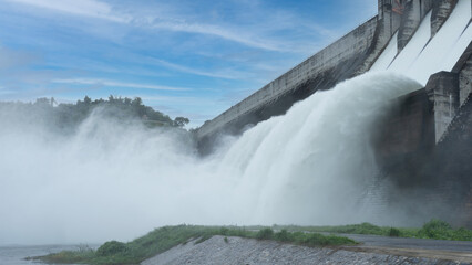 Hydroelectric dam Floodgate with flowing water through gate and Open the springway Khun Dan Prakan...