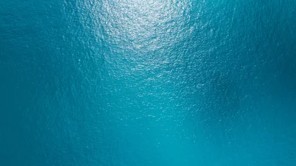 Fotobehang Zee Sea surface aerial view,Bird eye view photo of blue waves and water surface texture Blue sea background Beautiful nature Amazing view sea background  © Panya