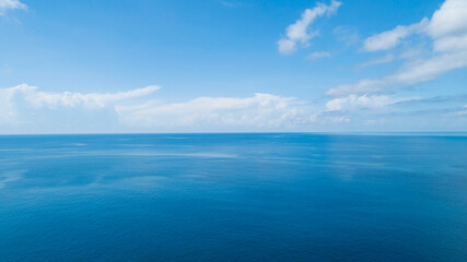 Aerial view of a blue sea surface water texture background and sun reflections Aerial flying drone...