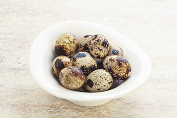 Raw quail eggs heap in the bowl