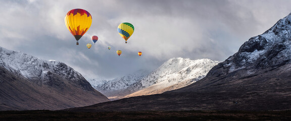 Digital composite image of hot air balloons flying over Majestic beautiful Winter landscape image of Lost Valley in Scotland