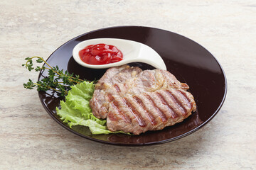 Grilled pork neck steak with ketchup