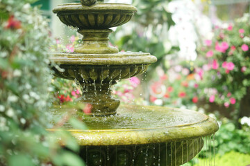 water flowing fountain decorating in garden - obrazy, fototapety, plakaty