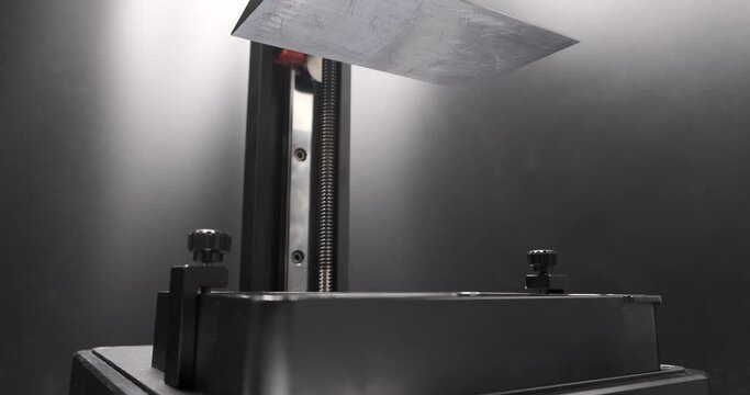 Consumer 3D resin printer, Resin MSLA 3D printer built plate coming down into resin vat at the start of 3D printing. 